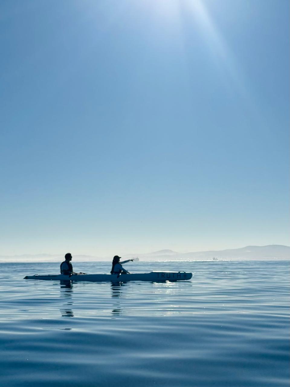 A kayak on a glassy morning sea