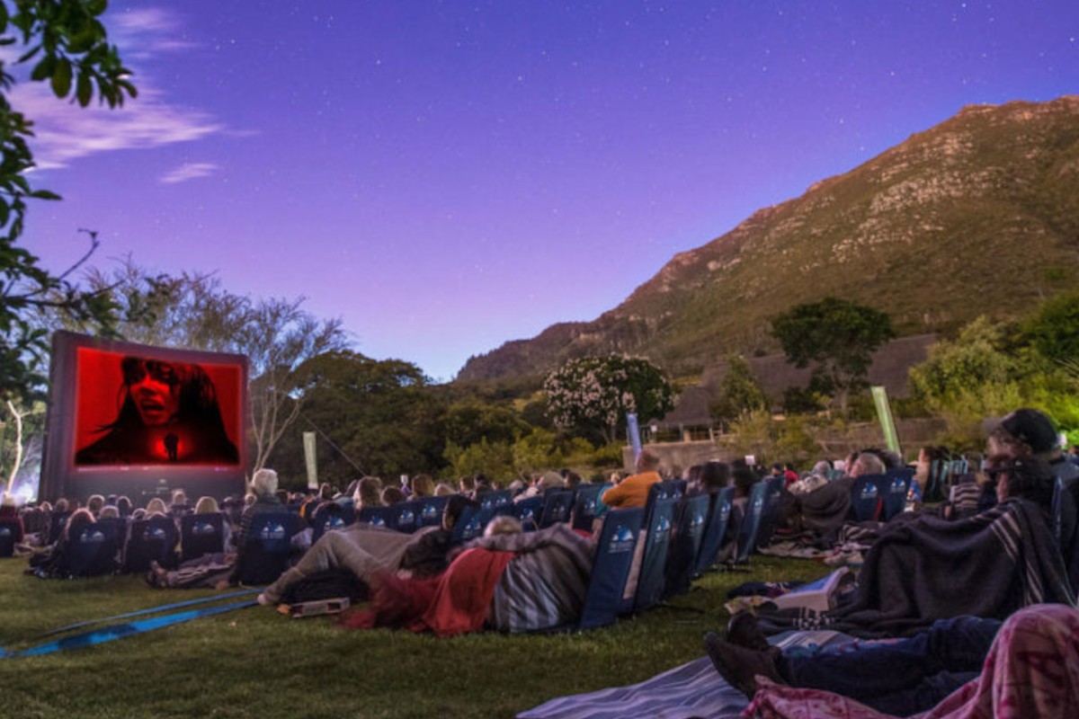 Open-air cinema screening at Kirstenbosch under the mountain at dusk