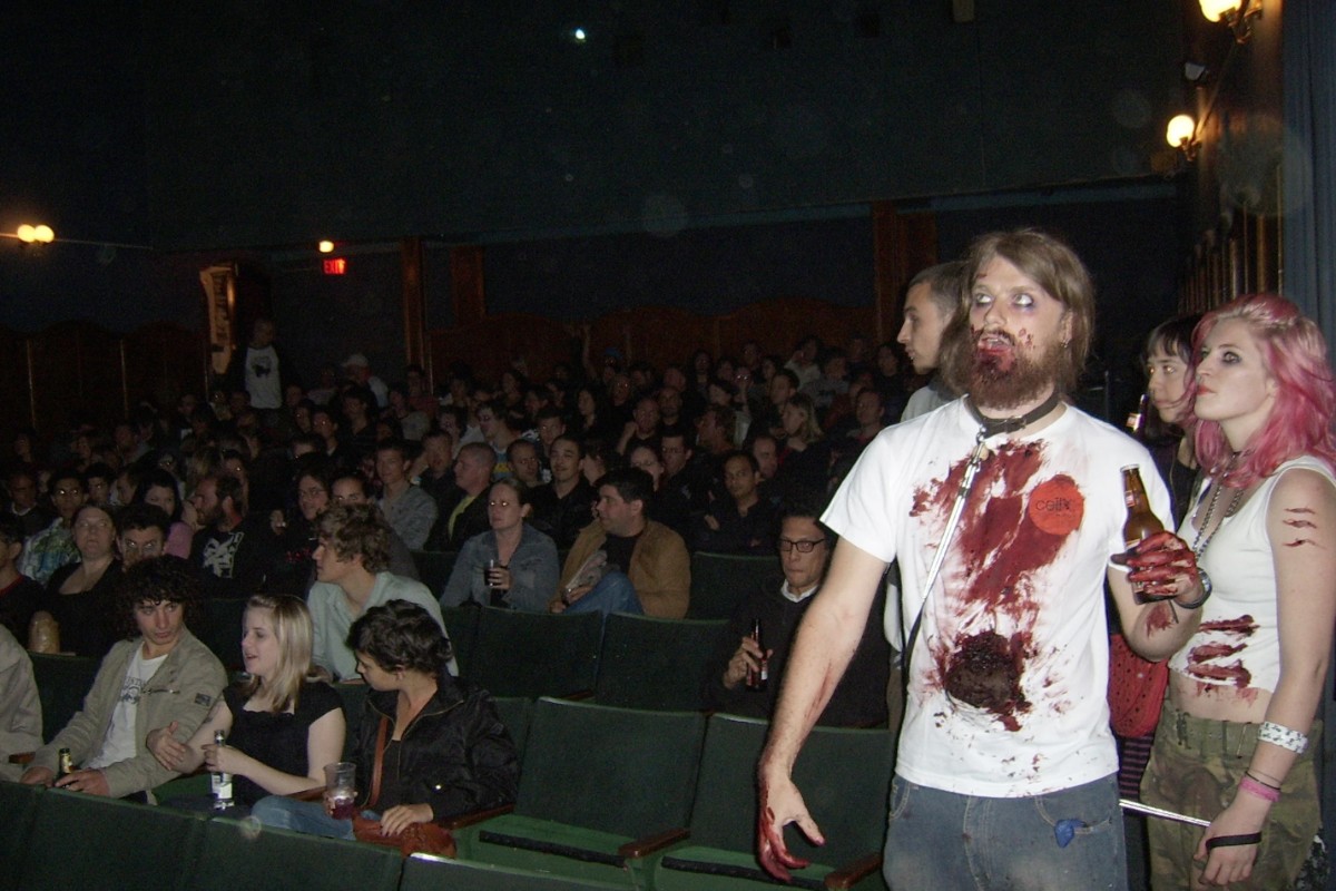 Costumed zombies at a horror film screening in a cinema