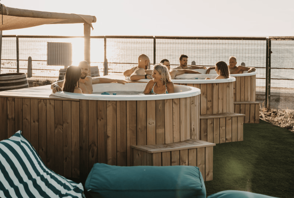 Hot tubs on the SaunaHaüs deck at sunset, Mouille Point